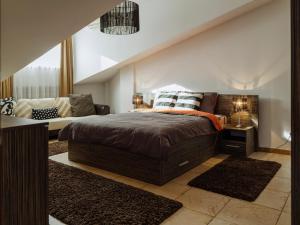 a bedroom with a bed and a couch at Penthouse with stunning view over the city and large terrace in Bucharest