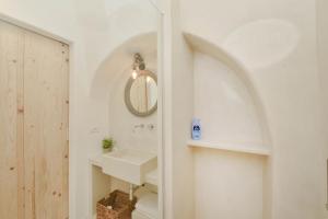 a bathroom with a sink and a mirror at CASA FLAMI' 3 in Ostuni