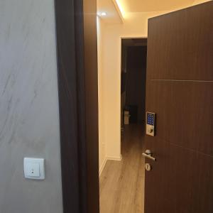 a door leading to a hallway with a hallway at Stars lux room in Belgrade