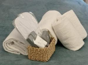 a basket of tissues and towels on the floor at B&B Toscana in Pisa