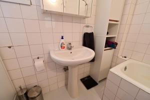 a white bathroom with a sink and a toilet at FLH - Wadema Villa in Sibiu +36 photos