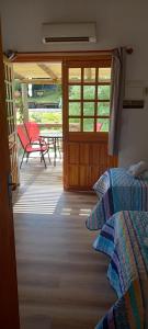 a bedroom with two beds and a deck with a patio at Malta Homestay in José Ignacio