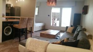 a living room with a couch and a table at ❊ L'ECRIN SELESTADIEN ❊ in Sélestat +9 photos