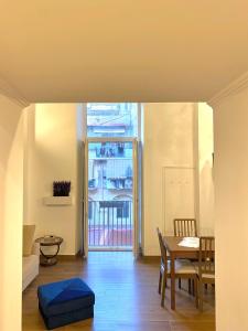 a living room with a table and a dining room at Silvi's House in Naples