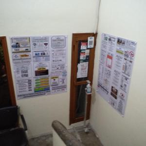 Un mur avec des affiches et des papiers. dans l'établissement Best Homestay,Centrally located,Chandigarh,160018, à Chandigarh