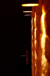 a brick wall with lights on it at night at L'Emperador in Reims