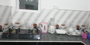 a counter top with a blender and cups of food at Sandu Guest in Mirissa