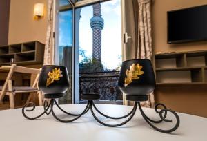 two black chairs with a view of the eiffel tower at 1BD Apartment with a Cute Balcony in Kapana by Flat Mаnager in Plovdiv
