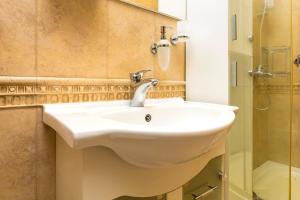 a bathroom with a white sink and a shower at 1BD Apartment with a Cute Balcony in Kapana by Flat Mаnager in Plovdiv +16 photos