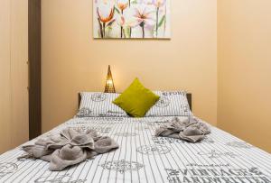 a bedroom with a bed with towels on it at 1BD Apartment with a Cute Balcony in Kapana by Flat Mаnager in Plovdiv