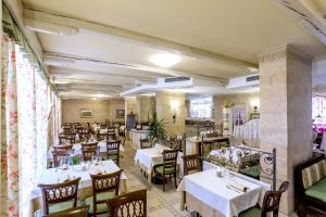 restauracja ze stołami i krzesłami w pokoju w obiekcie Sartori's Hotel w Trydencie