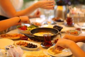 a table topped with plates of food and bowls of food at Park Hotel Rooms & Apart in Antalya +93 photos