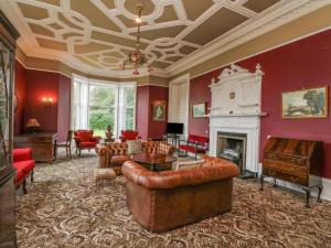 a living room with a couch and a fireplace at Woodside House in Arbroath