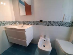 a bathroom with a sink and a toilet at Casa Isabea in Pozzuoli