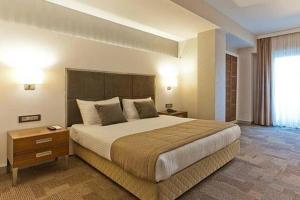 En eller flere senge i et værelse på Kalinda Inn Hotel Ilıca Cesme