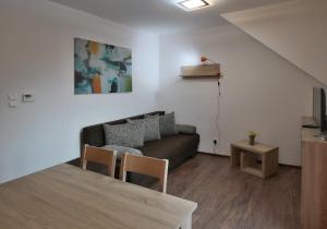 a living room with a couch and a table at Apartmany Maliarik in Demanovska Dolina