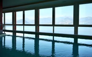 a swimming pool with a view of the water at Il Porticciolo in Laveno-Mombello