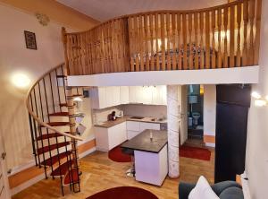 a kitchen with a spiral staircase in a house at River Residence in Timişoara