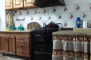 a kitchen with a stove and a counter top at Depto La Cuni in Goya