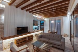 a living room with a couch and a tv at The Valley Resort in Riyadh
