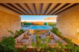 an outdoor patio with a swimming pool and plants at The Valley Resort in Riyadh +40 photos