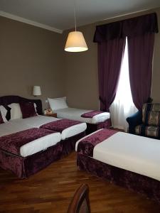 a hotel room with two beds and a window at Hotel delle Terme & SPA in Fiuggi