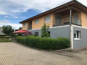 a building with a balcony on the side of it at FeWo Golden Palace in Ettenheim