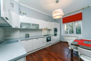 a kitchen with white cabinets and a table with chairs at 2х комнатная, Крещатик 23, VIP, Центр, Просторная, Тихая in Kyiv