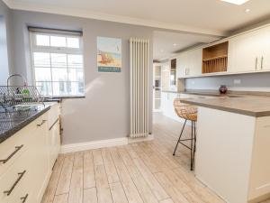 a kitchen with white cabinets and a counter top at 17 St Magnus Close in Birchington