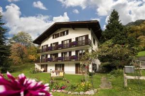 a large white house with flowers in the yard at Ferienhaus Dr. Schorm in Schruns