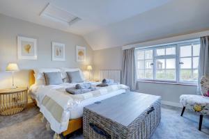 a bedroom with a large bed and a window at Mariners Hard, Cley-Next-The-Sea in Cley next the Sea