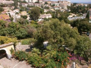 a view of a city with trees and flowers at Hôtel Paradis in Bormes-les-Mimosas
