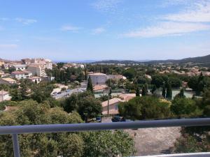 a view of a city from a balcony at Hôtel Paradis in Bormes-les-Mimosas