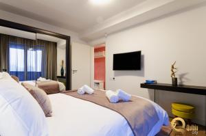 a hotel room with two beds and a flat screen tv at Quibio City in Braşov