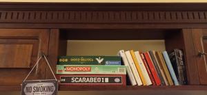 a group of books sitting on a book shelf at Casetta Angie in Barrea