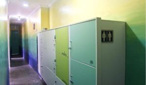 a room with green and white lockers and a hallway at Belem Hostel in Belém