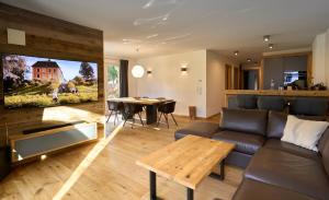 a living room with a couch and a table at Chalet Alpenspirit in Garmisch-Partenkirchen