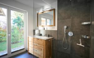 a bathroom with a sink and a mirror at Chalet Alpenspirit in Garmisch-Partenkirchen +20 photos