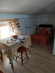 a living room with a table and a couch at Gologanova house in Kalofer +47 photos