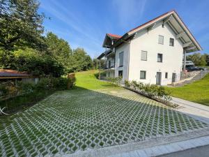 a house with a cobblestone driveway in front of a house at Sweet Home Apartment Ammersee - eco-friendly, Boxspring, Garden, WiFi in Inning am Ammersee