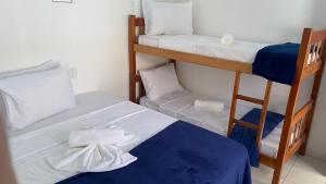 a couple of bunk beds in a room at Pousada Cores da Passarela - Sob nova direção in Porto Seguro