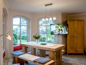 a living room with a table and a tv at Modern Bungalow in Tessmannsdorf on Coastal Forest in Teßmannsdorf