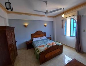 a bedroom with a bed and a window at Enjoy Luxor in Luxor