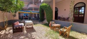 a yard with chairs and tables in a house at Enjoy Luxor in Luxor