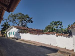 a white wall with plants on it next to a street at Florré Blossom in Barichara