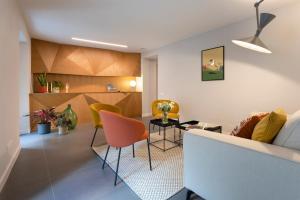 a living room with a couch and chairs at Camere d'Aria in Locana