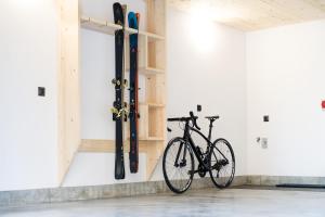 a bike parked in a room with skis on the wall at Mount Apart Sport House in Zakopane
