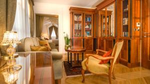 a living room filled with furniture and a fireplace at Judita Palace Heritage Hotel in Split