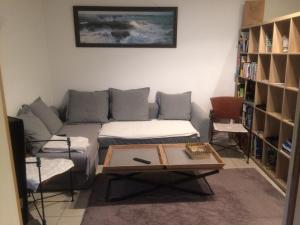 a living room with a couch and a coffee table at APPARTEMENT CONLEAU VANNES une Chambre WIFI in Vannes