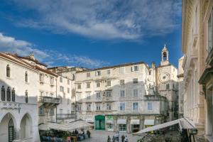 a group of buildings in a city with a clock tower at Judita Palace Heritage Hotel in Split